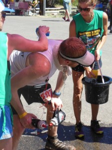 Like most runners, Brian Miller gets sponged down at Michigan Bluff (SRN Photo)