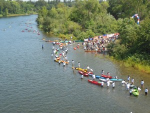 Racers stream into the finish and an army of volunteers pass the boats on up to the shore. (SRN photo)