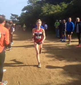 Olivia Mickle (Bowerman TC) races to the finish while dad (blue jacket) cheers her on. (Photo courtesy of Maria Kelly)